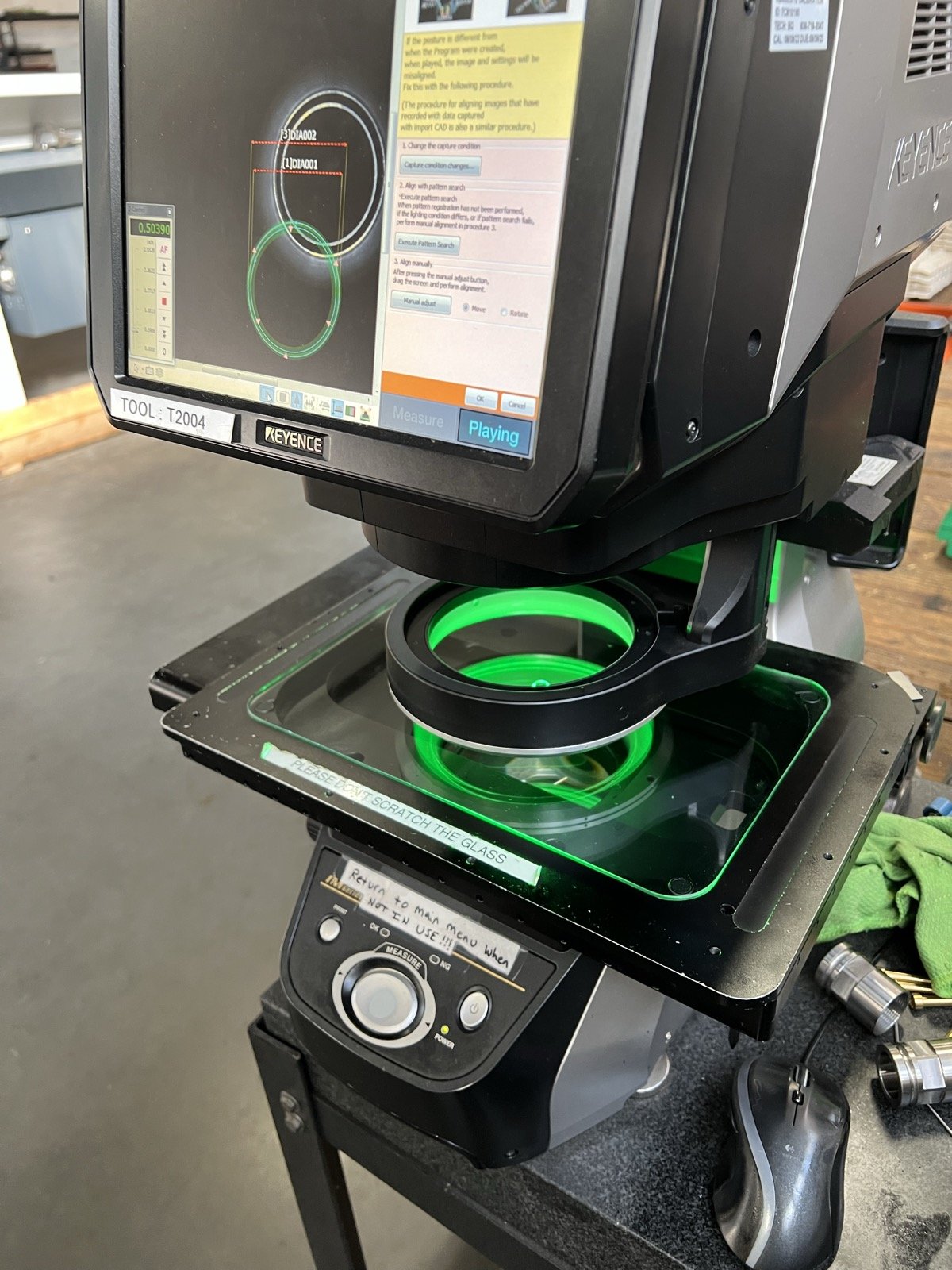 TXSwiss Keyence optical comparator displaying dimensional measurement readings on screen during quality inspection
