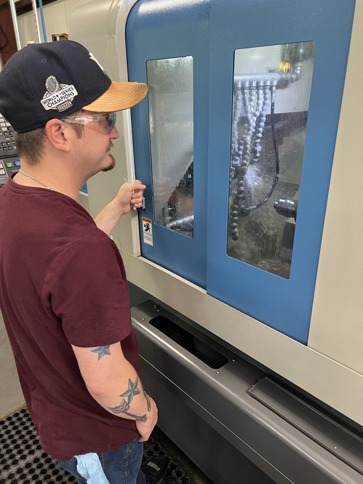 TXSwiss machinist running a Tornos bar-fed Swiss CNC machine in Conroe, Texas