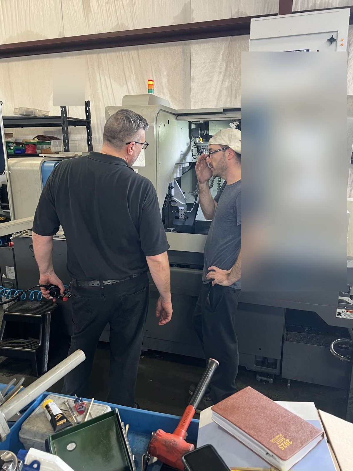 TXSwiss machinists running a Nomura NN-32 Swiss CNC lathe with mist filtration at the Conroe, Texas facility
