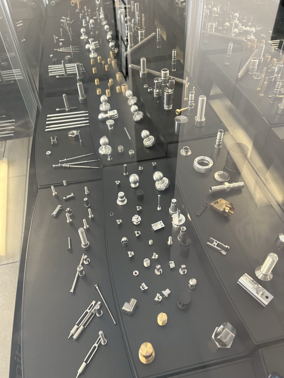TXSwiss precision Swiss CNC machined components in stainless steel, brass, and aluminum on display at the Conroe, Texas facility