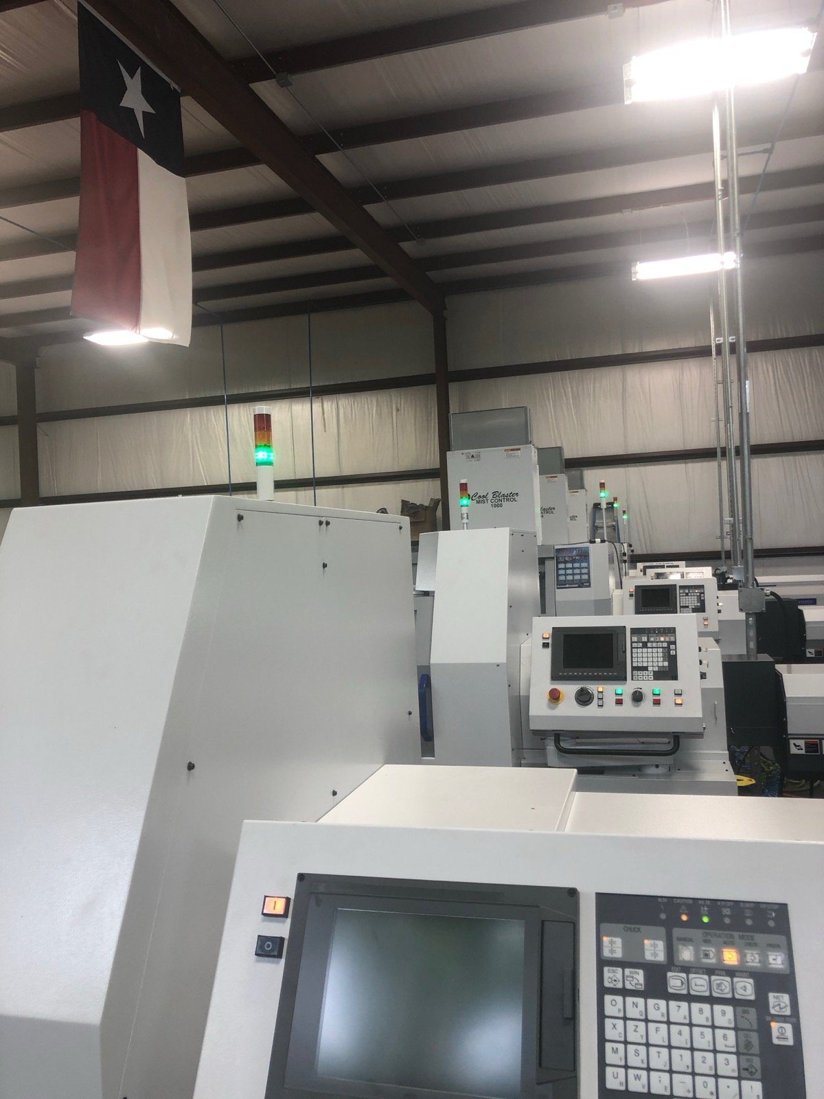TXSwiss Swiss CNC production machine row showing multiple precision lathes in Conroe, Texas