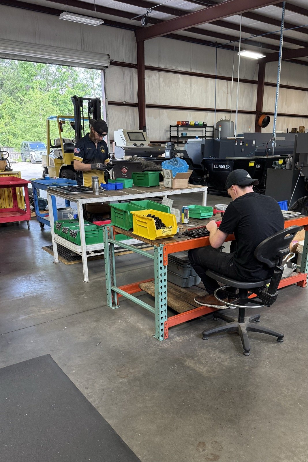TXSwiss machinists working in the parts inspection, packaging, and quality control area at the Conroe, Texas precision Swiss CNC machining facility